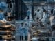 Engineers work across semiconductor fabrication, data-centre infrastructure and an automated factory with industrial and humanoid robots.