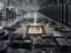 Semiconductor wafers, AI computing modules and data-centre racks converging around a central processor in a large industrial facility