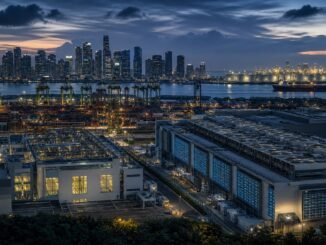 Singapore’s skyline, container port, data-centre infrastructure and an oil tanker at blue hour, illustrating technology-led growth alongside imported energy costs.